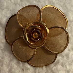 vintage gold-tone flower brooch with mesh petals and a central rose desig
